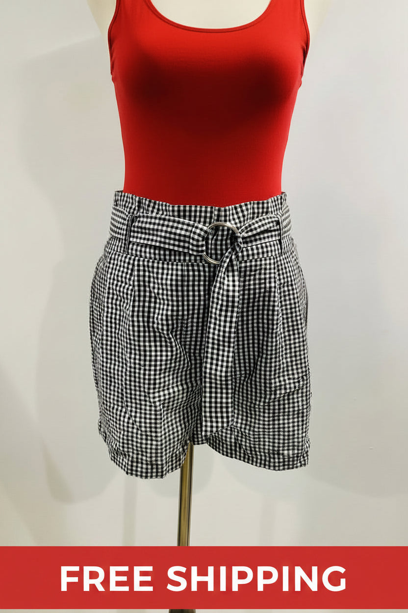 Black and white checkered shorts on a mannequin against a plain background
