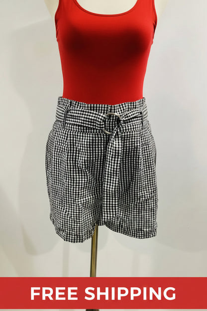 Black and white checkered shorts on a mannequin against a plain background
